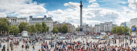 Trafalgar Square in London with blue sky and tourists passing by on August 13, 2014のeditorial素材