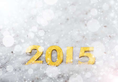 2015 year golden figures on snow background