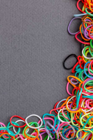 Loom rubber bands frame on gray backgroundの写真素材