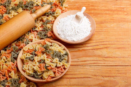 Dry farfalle in wooden bowlの写真素材