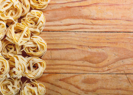 Tagliatelle on rustic wooden boardの写真素材