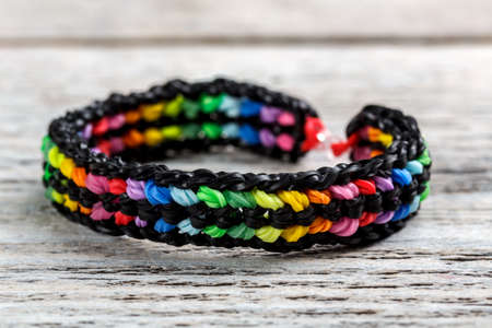 Colorful elastic rainbow bracelet on wooden background.の写真素材