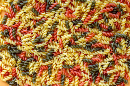 Colourful fusilli pasta background, italian pastaの写真素材