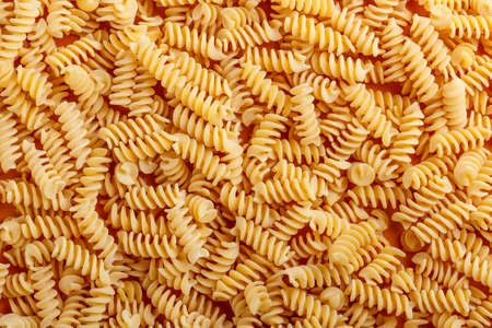 Italian fusilli pasta, raw food background
