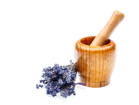 Wooden mortar with dry lavender flowers over white backgroundの写真素材