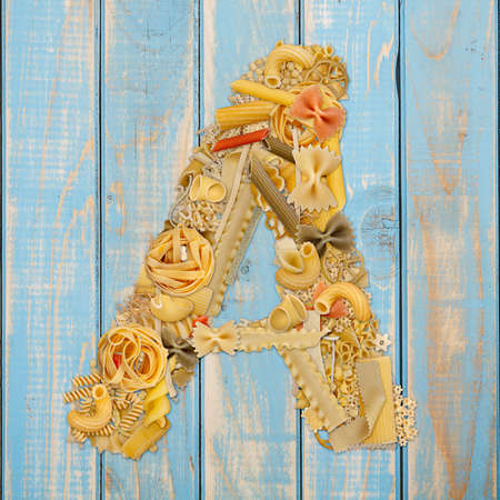 Letter A made from pasta on a blue wooden  backgroundの写真素材