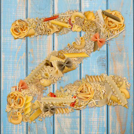 Letter Z made from pasta on a blue wooden  backgroundの写真素材