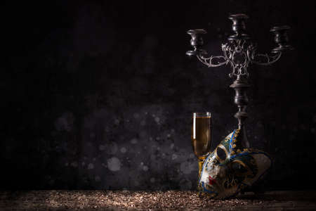 Female carnival mask with glass of champagneの写真素材
