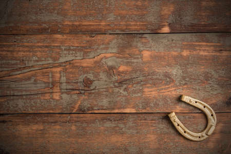 Lucky horseshoe on old wooden backgroundの写真素材