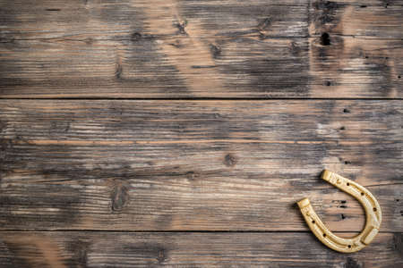 Lucky horseshoe on old wooden backgroundの写真素材