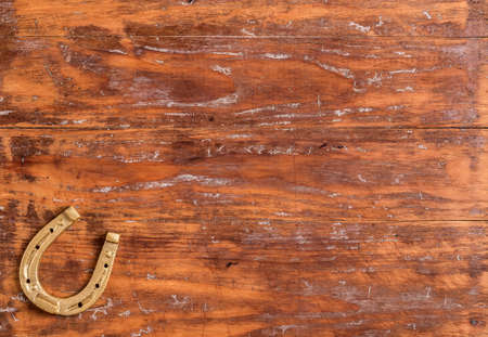 Lucky horseshoe on old wooden backgroundの写真素材