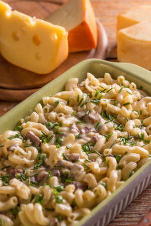 Macaroni with cheese, bacon and peasの写真素材