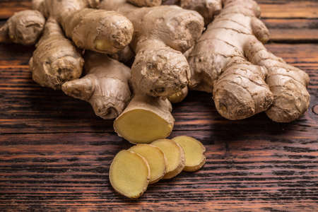 Ginger root sliced on wooden tableの写真素材