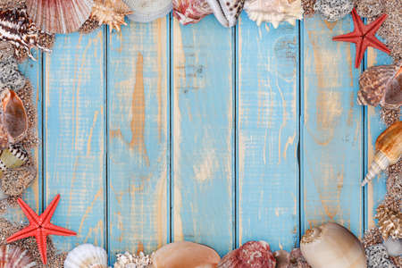 Sea shells frame on vintage shabby wooden boardの写真素材