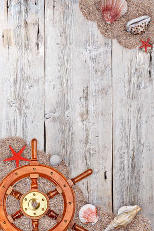 Sea concept with steering wheel on vintage wooden surfaceの写真素材