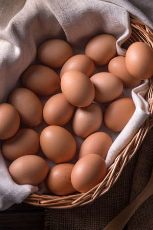 Organic eggs in wicker basketの写真素材