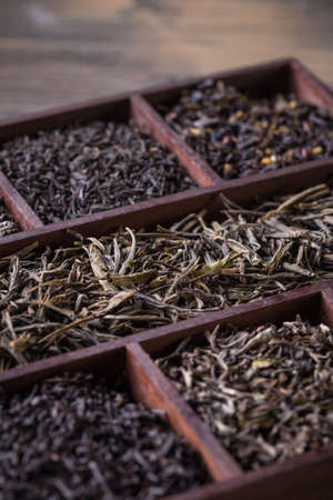 Close up assortment of dry tea in wooden boxの写真素材
