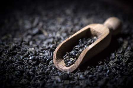 Wooden scoop with black tea