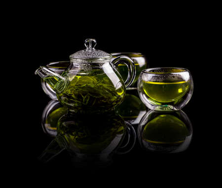 Tea in glass cup and potの写真素材