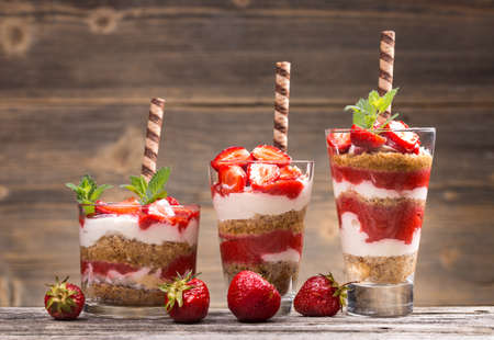 Fresh strawberry yogurt parfait on wooden backgroundの写真素材