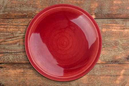 Red plate on wooden backgroundの写真素材