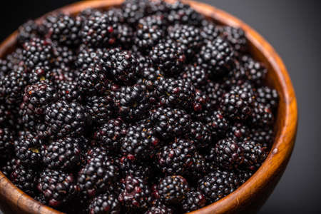 Wooden bowl of blackberries, close upの写真素材