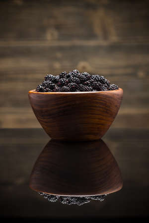 Bowl of blackberries on reflection surfaceの写真素材
