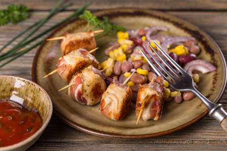 Meatballs rolled in bacon with tomato sauceの写真素材