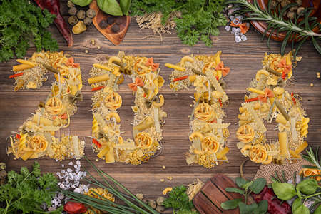 2016 year text made of pasta on rustic background with herbsの写真素材