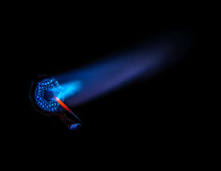 Close up of the end of a blowtorch with the blue flameの写真素材