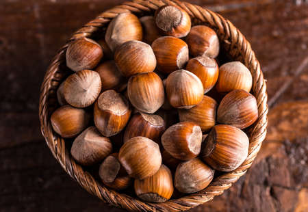Top view of hazelnuts in a wooden bowl