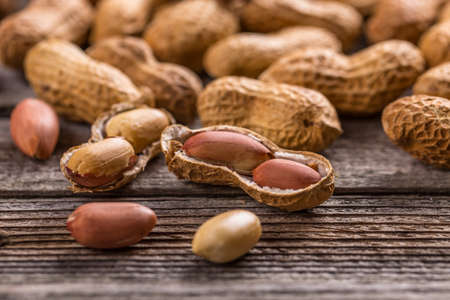 Peanuts in shells on vintage wooden background