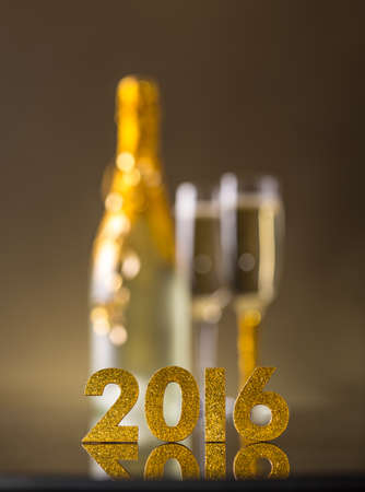 2016 year golden figures, champagne in background