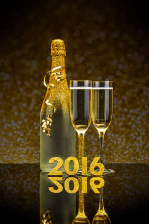 Celebration theme with champagne on gilded backgroundの写真素材