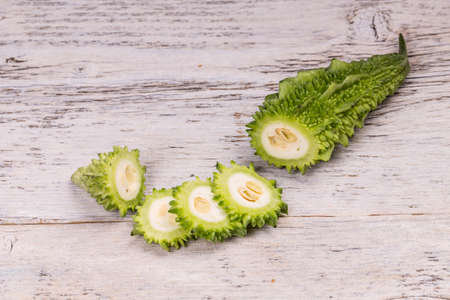 Bitter melon on white wooden backgroundの写真素材