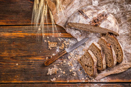 Top view of sliced artisan bread on vintage wooden surfaceの写真素材