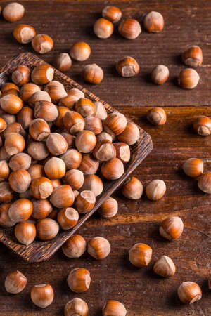 Top view of hazelnuts on old wooden backgroundの写真素材