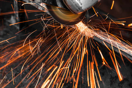 Grinding machine in action with bright sparks.の写真素材