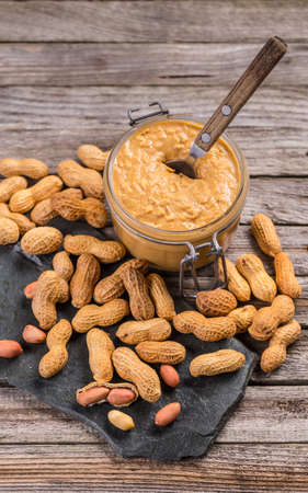 Fresh made creamy peanut butter in a glass jar