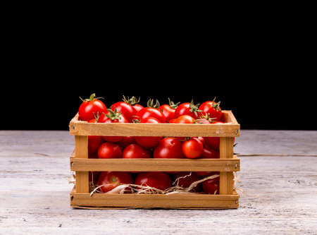 Crates of tomatoes on a white wooden boardの写真素材