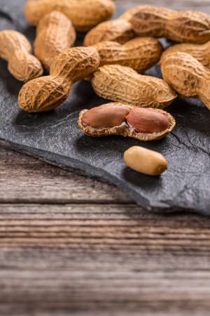 Half and whole peanut on stone background