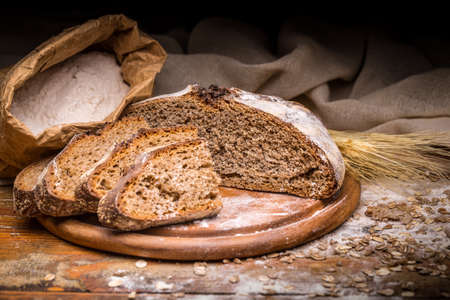 Wholegrain rye bread on cutting boardの写真素材