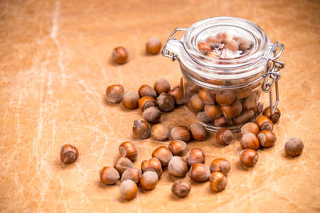 Hazelnuts in closed glass jarの写真素材