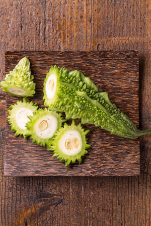 Bitter melon slice on wooden plateの写真素材