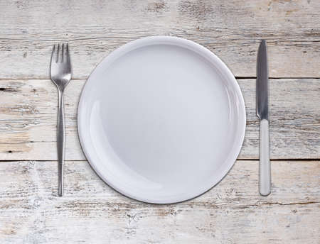 Knife and fork with white plateの写真素材