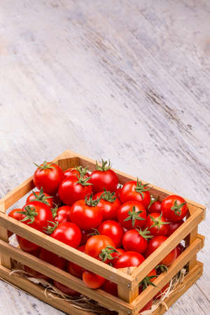 Fresh tomatoes in a wooden crateの写真素材