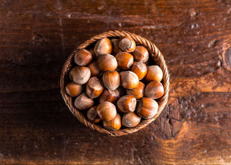 Top view of hazelnuts in rustic wooden bowlの写真素材