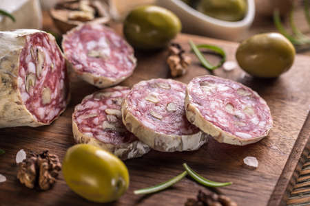 Salami with walnut on wooden backgroundの写真素材