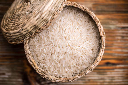 Top view of long grain rice in a wicker basketの写真素材
