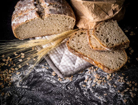 Still life of fresh bread on the black backgroundの写真素材